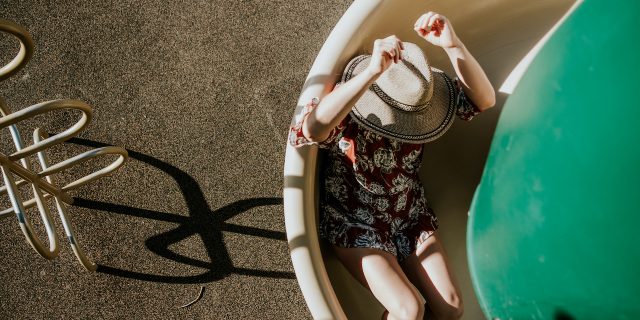 overhead view of a woman sliding down a spiral slide