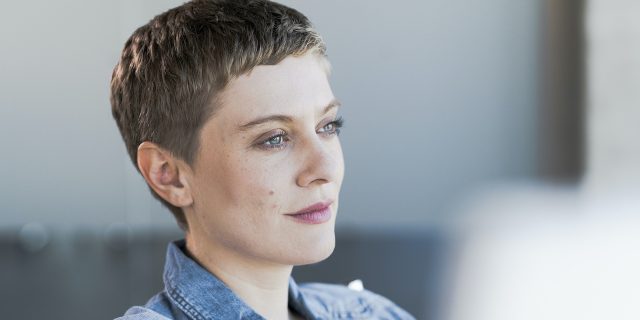 Woman with short brown hair looking into the distance