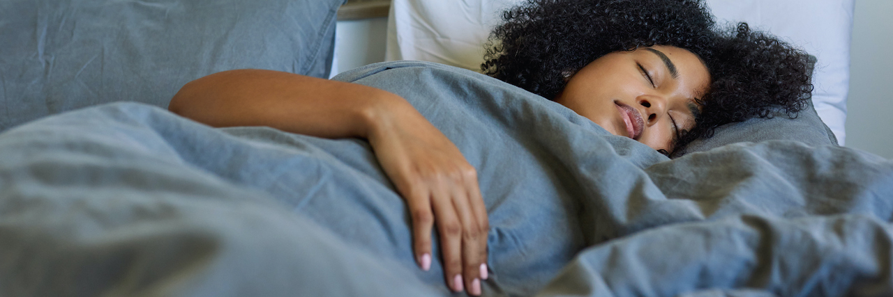 Black woman asleep in bed