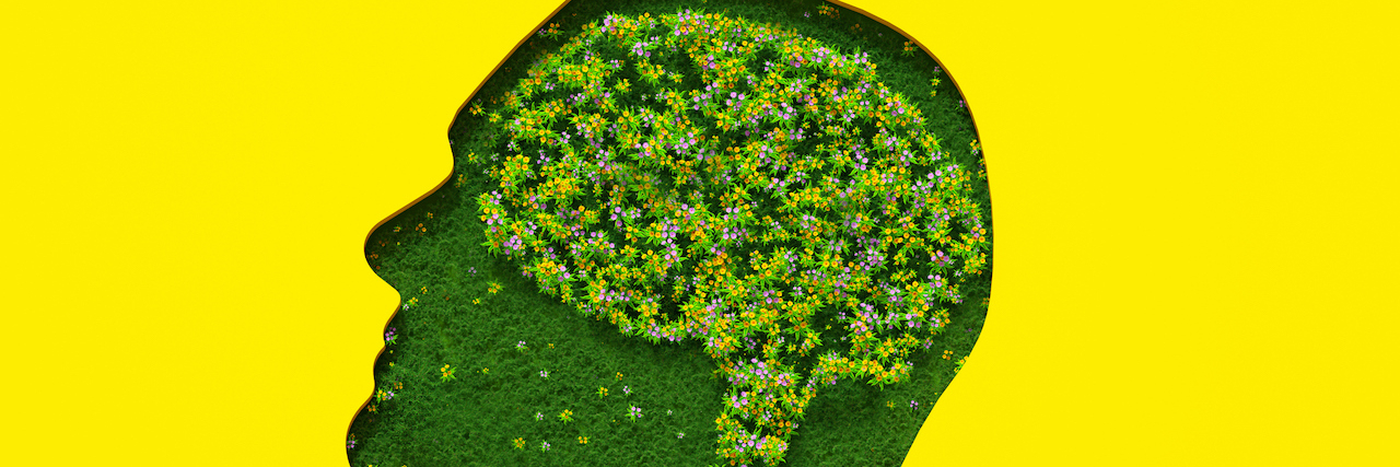 Is Procrastination a Sign of ADHD? What You Need to Know Flowers petals and leaves forming brain shape inside silhouette of head made out of grass on yellow background.