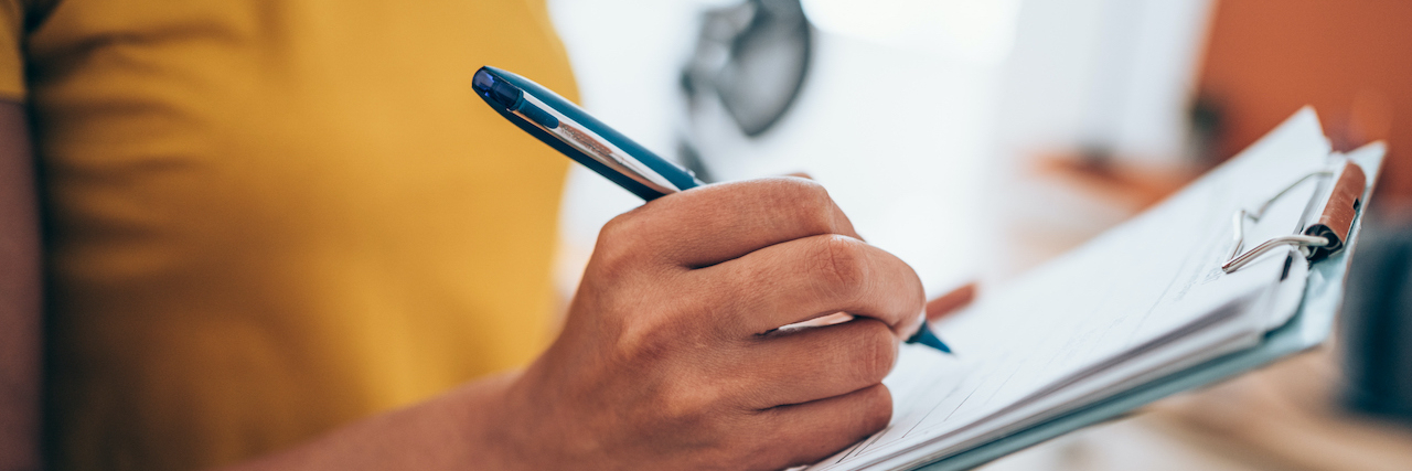 Questions to Ask & Things to Share With Your Healthcare Provider If You Have PBC Cropped shot of an woman's hand making notes on a clipboard in an office