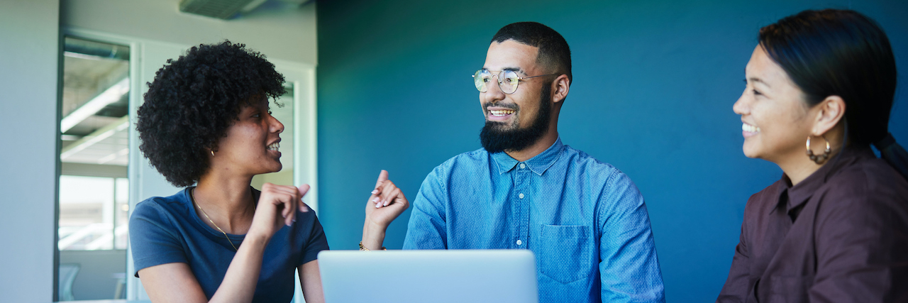Unlocking Your Potential: Discover the Best Jobs for People with ADHD Group of a diverse young professionals smiling and talking together with a laptop in an office