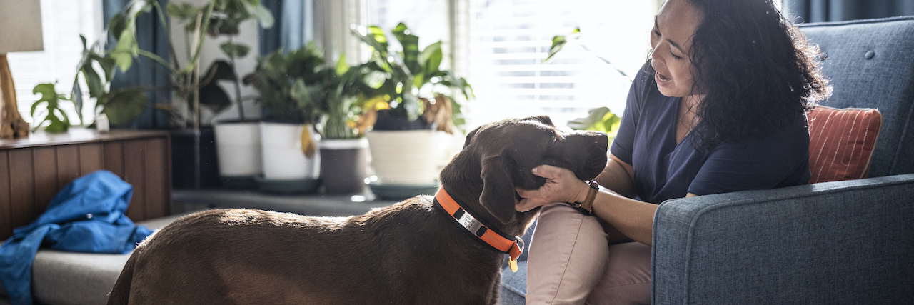 Can You Get a Service Dog for ADHD?  Woman petting dog at home