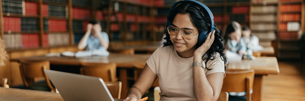 Is ADHD a Learning Disability? Unpacking the Relationship Female Indian student working on laptop in the library