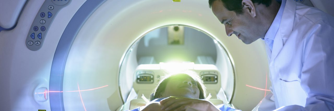 Doctor and patient using Magnetic Resonance Imaging (MRI) scanner