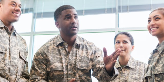 Military officer talks with diverse group of cadets