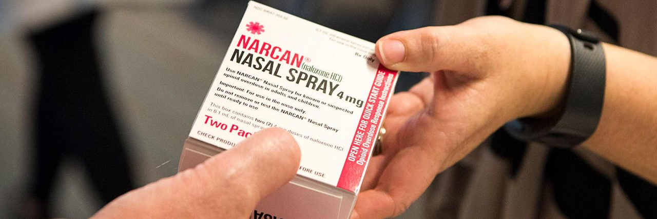 What Is Narcan: The Lifeline You Never Want to Use but Should Know About Hands exchanging NARCAN (Naloxone nasal spray)