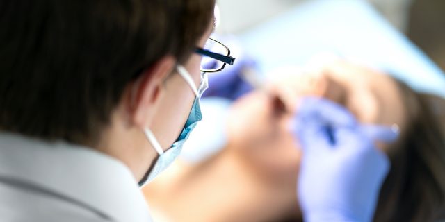 Can Wisdom Teeth Cause Migraine? Exploring the Link View from above of dentist working on patient