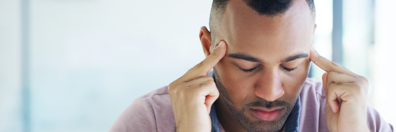 Cluster Headaches vs. Migraine: What’s the Difference? Closeup of man holding his fingers to his temples