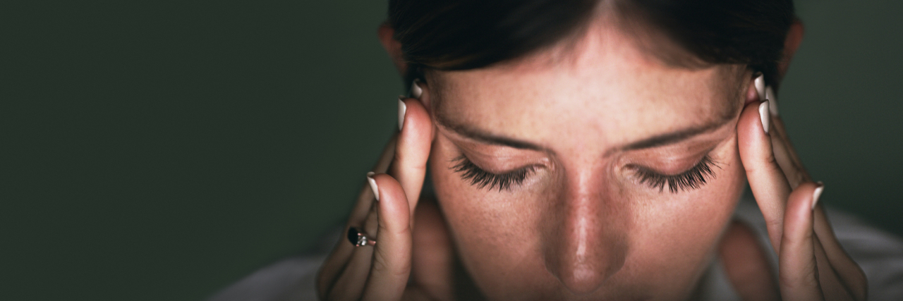 Migraine vs. Headache: Understanding the Difference Closeup of woman holding fingers to her temples, with eyes closed