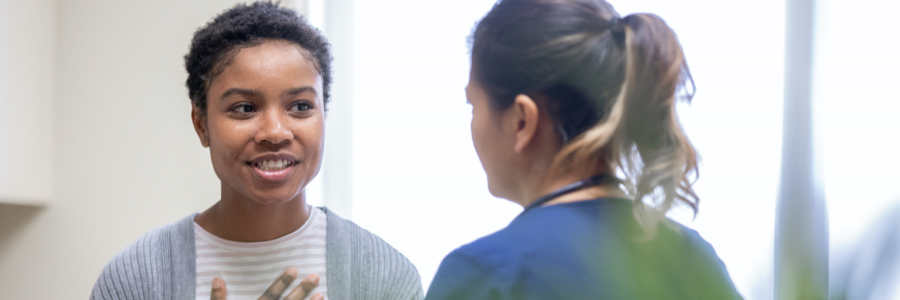 Understanding Hemiplegic Migraine's Risks Medical professional having discussion with patient