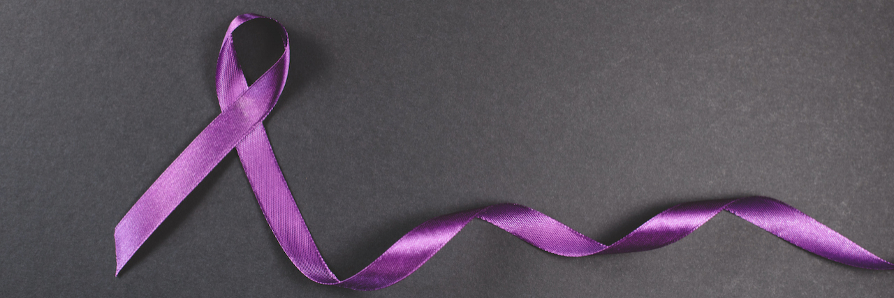 The Importance of Epilepsy Awareness Month Purple ribbon on black background. Symbol of epilepsy awareness