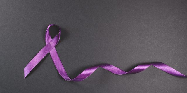 The Importance of Epilepsy Awareness Month Purple ribbon on black background. Symbol of epilepsy awareness