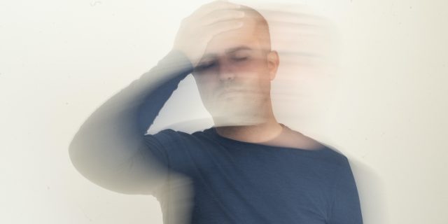Man holding his head with motion blur effect
