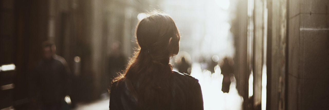 The Link Between Depression and Memory Loss Woman walking down misty street with blurry view