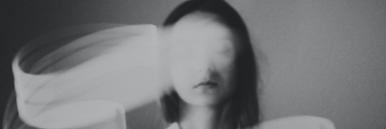Weird Migraine Symptoms You May Experience Woman with eyes closed and blurry white swirls around her
