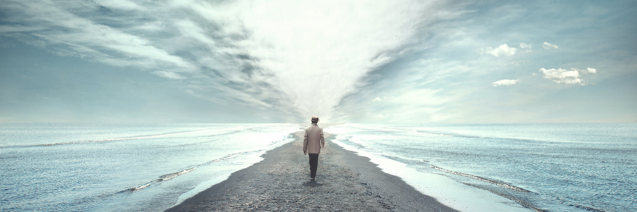 Man walking between two seas