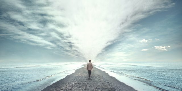 Man walking between two seas