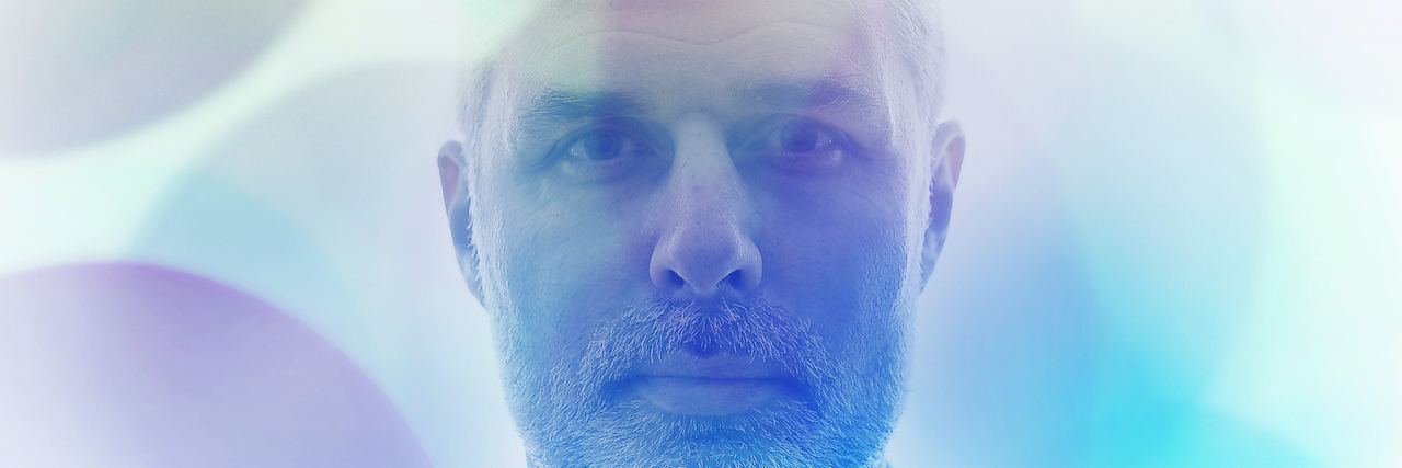 Signs Your Antidepressant Dose Is Too Low Portrait of man with blue spheres superimposed over hime