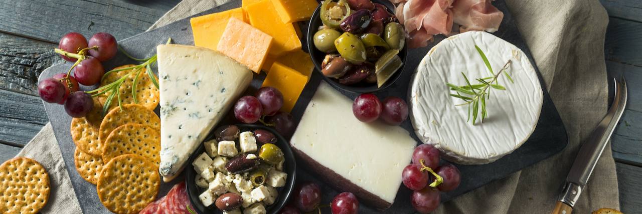 Exploring What Foods Can Trigger Migraine Charcuterie board with meat, cheese and grapes