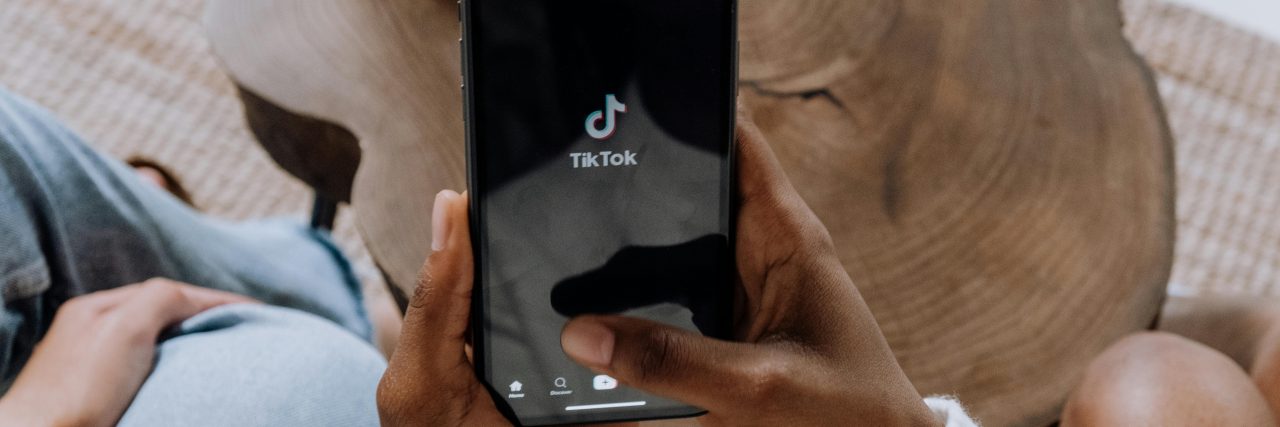 How Can You Protect Your Feed From SkinnyTok? Someone clicking on TikTok