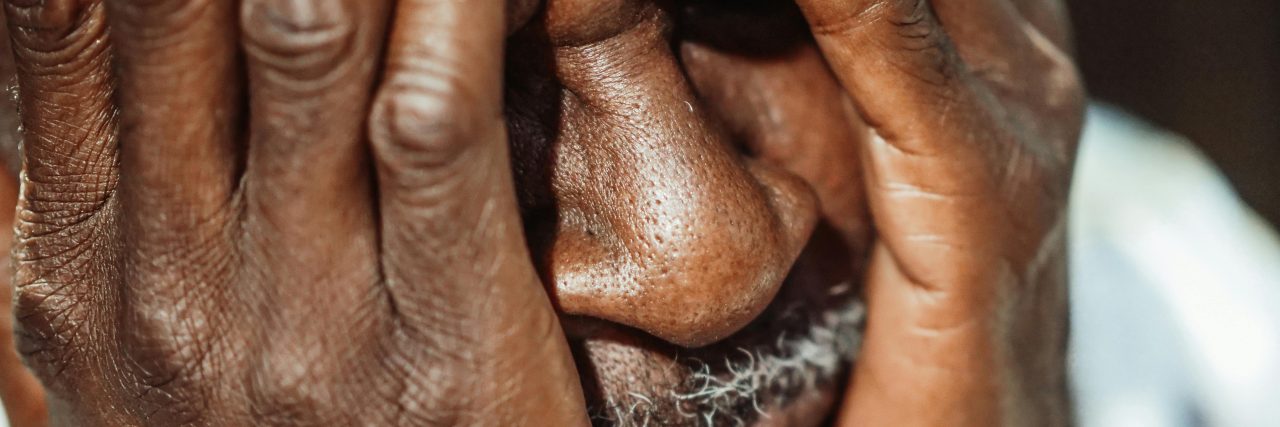 man in pain from migraine