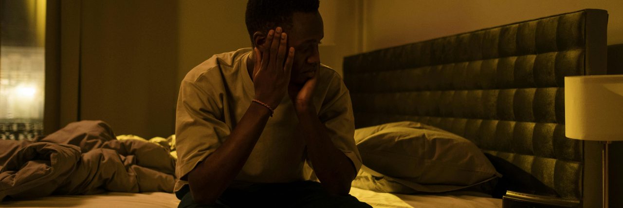 man awake at night in bed