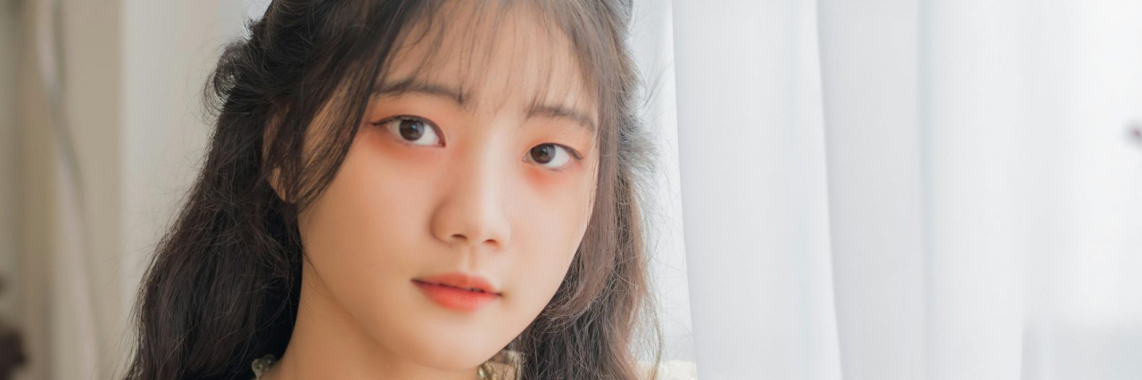 What Is a Silent Migraine? woman sitting down