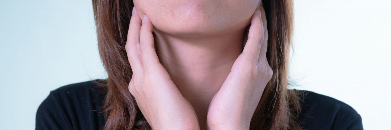 person holding sore throat