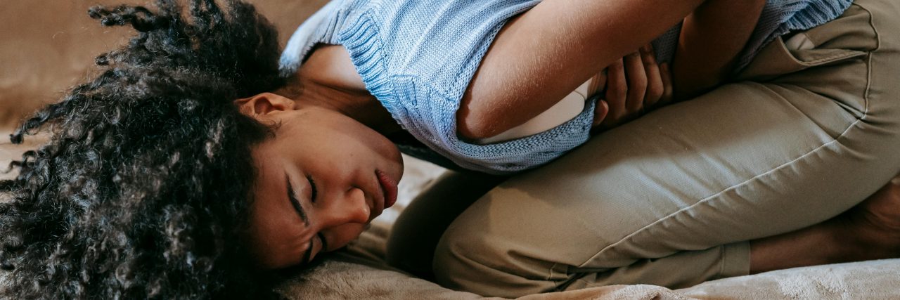 What Is Silent Endometriosis? person keeled over in pain