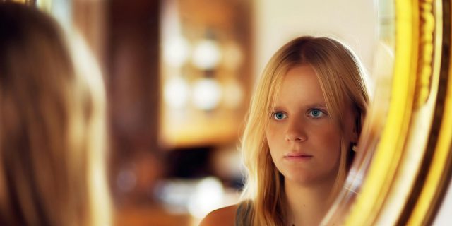 Signs of Covert Narcissism woman looking in a mirror