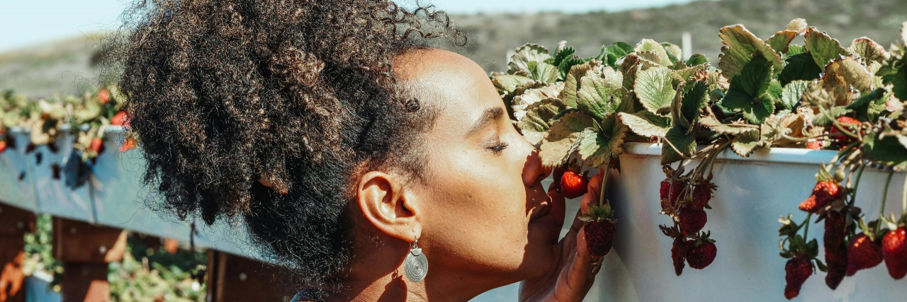 What Smells Trigger Migraines? person smelling flowers
