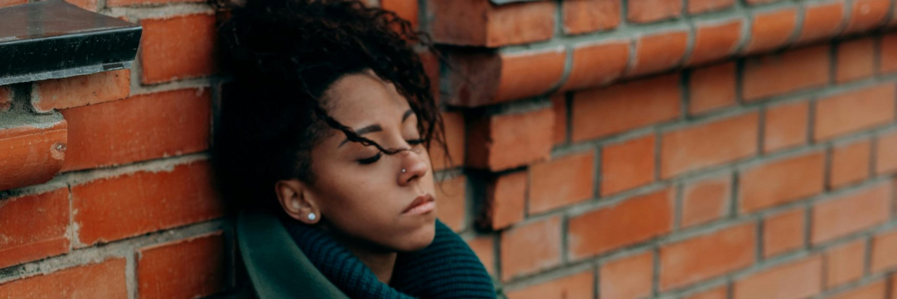 person sitting on the sidwalk