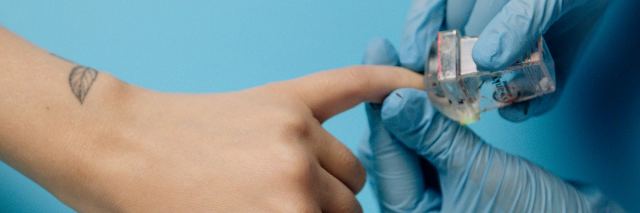 Doctor inspecting fingernails