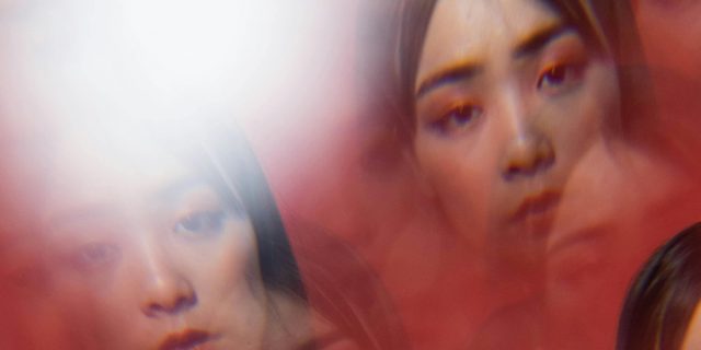 multiple faces in red fog