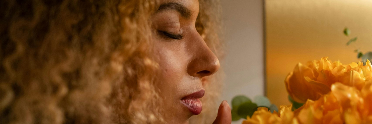 What Is Osmophobia? person smelling flowers