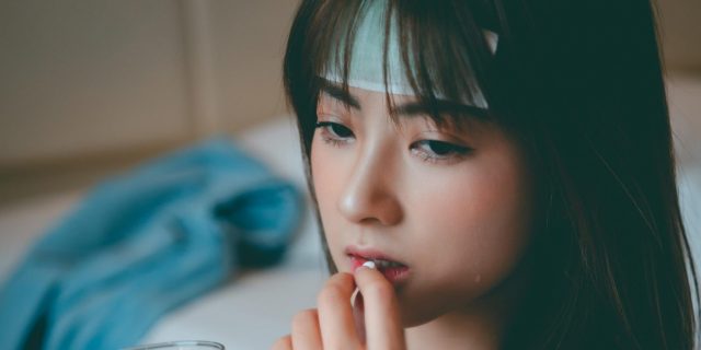 person taking medicine for a headache