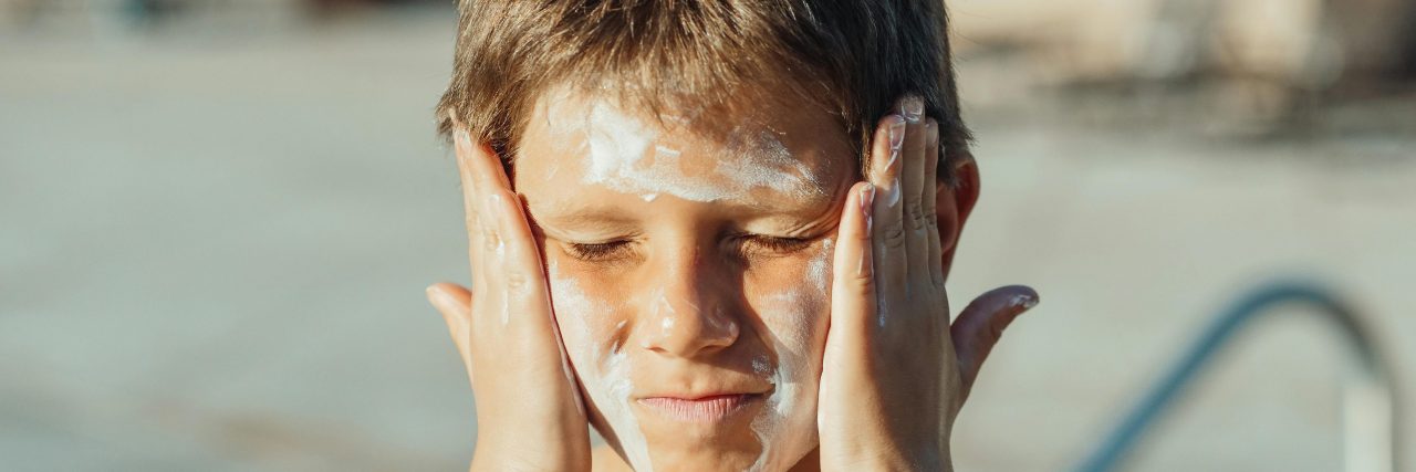 Types of Sun Allergies boy with sunscreen on