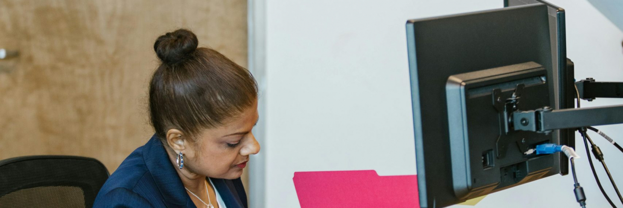 What Is 'Need-to-Know Anxiety'? woman looking up info in a folder
