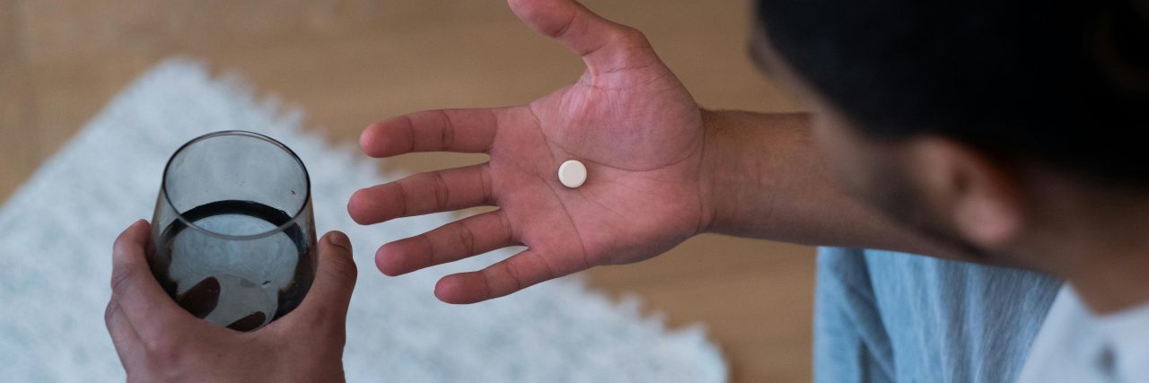 person holding pills