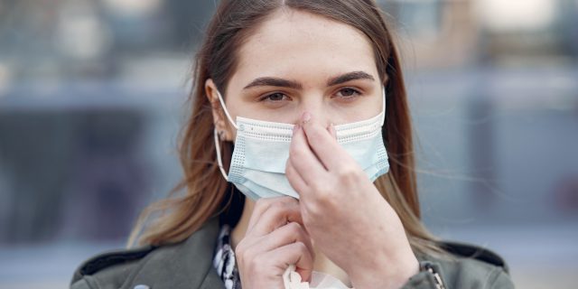 13 Signs of Hyperosmia: Why Smells Feel Stronger Than They Should person covering nose with mask