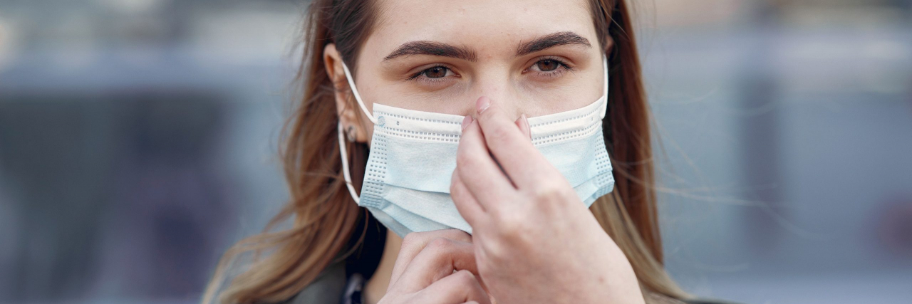 Signs of Hyperosmia person covering nose with mask