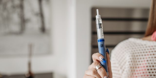 Is Microdosing GLP-1 Safe? What the Research Actually Says person holding glp-1 injector