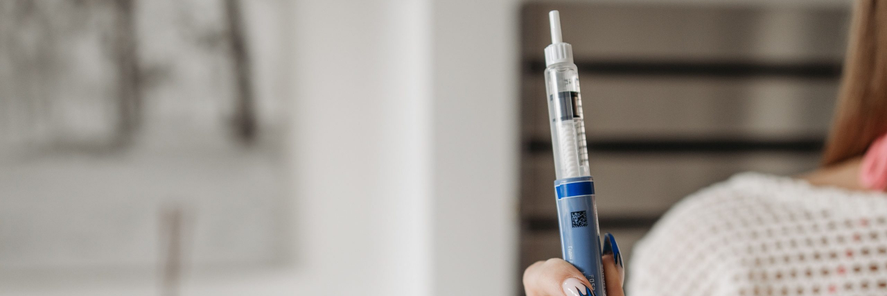 person holding glp-1 injector
