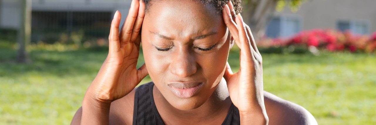 person outside with headache or nerve pain