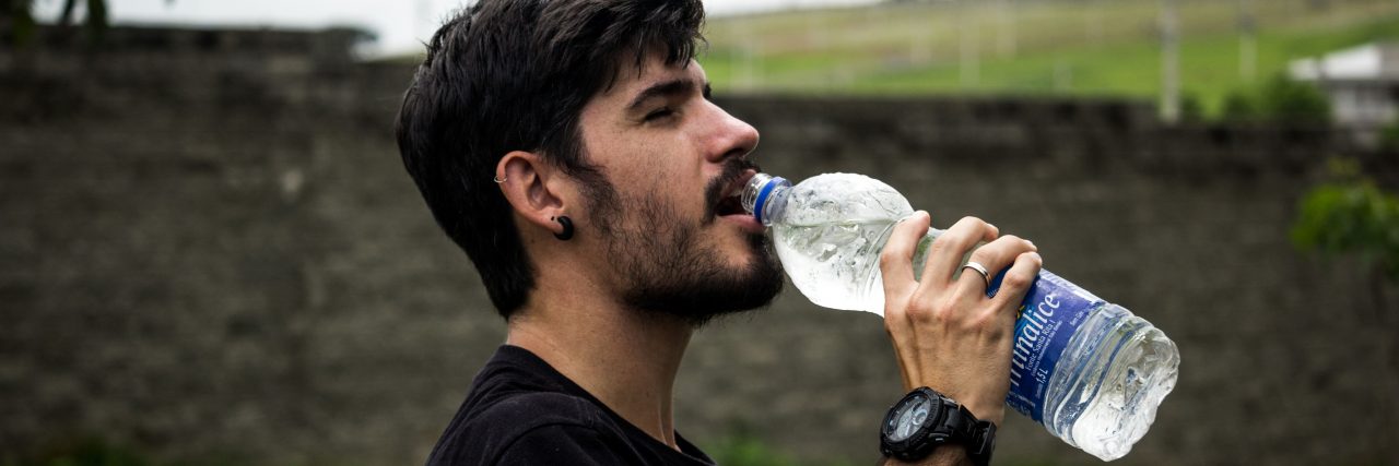What Is Polydipsia? person drinking a water bottle outside