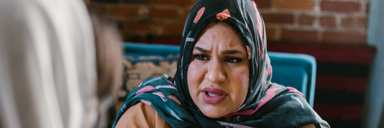 woman looking upset at what someone else is saying