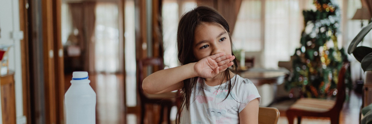 little girl with itchy mouth from drinking milk