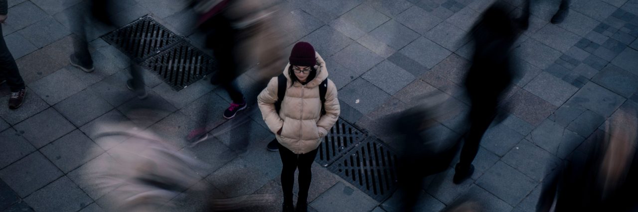 person alone in a crowd