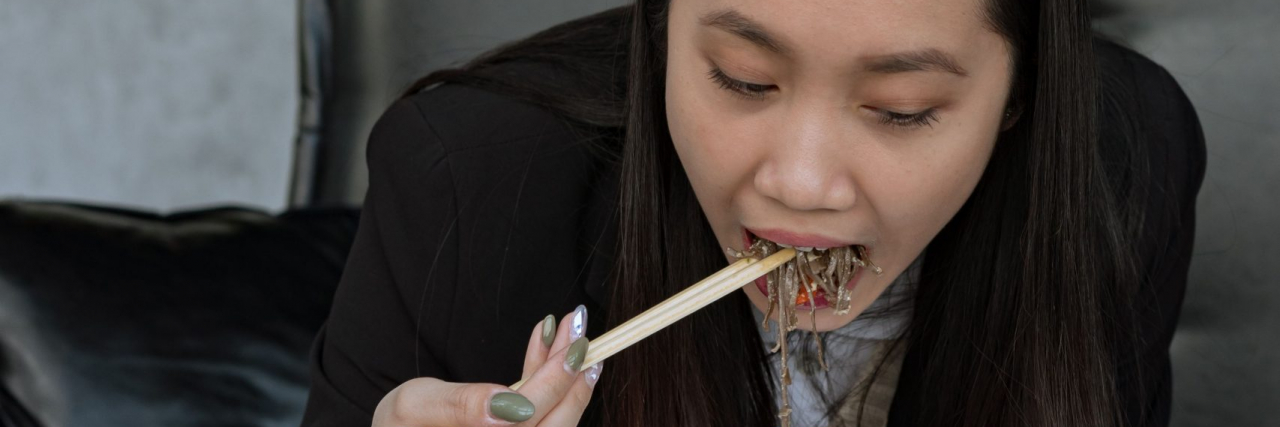 person eating spicy takeout